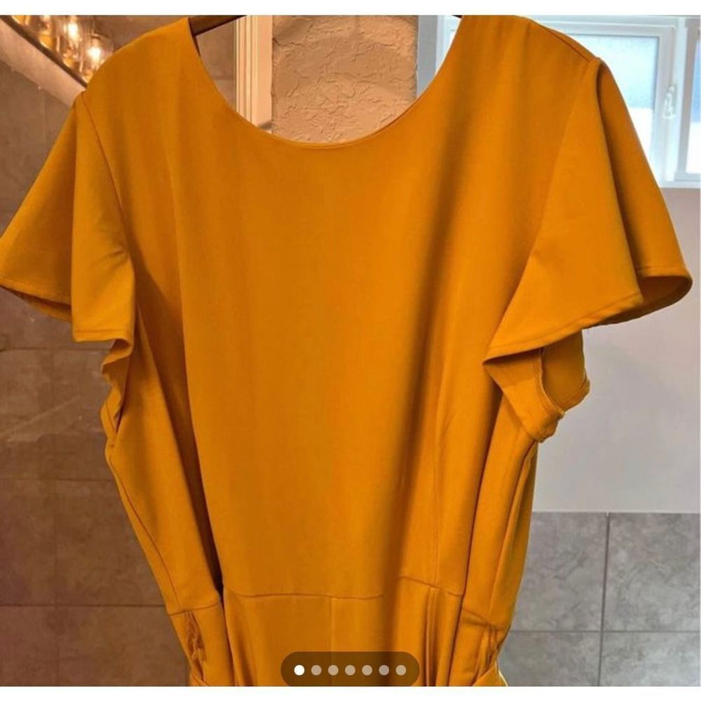 Mustard yellow jumpsuit from lane Bryant
New with tags.

Pockets, sash, and zipp